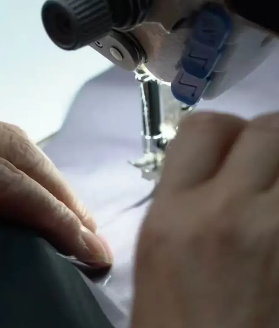 Close-up of precision stitching by hand and machine